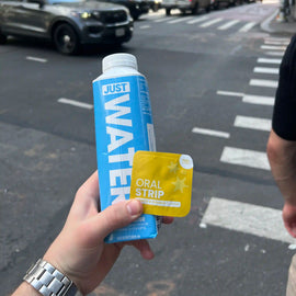 locked in party hangover supplement holding in hand with water