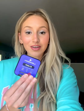 female smiling holding locked in sleep supplement in hand