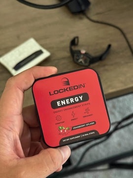 person holding locked in energy supplement at a desk working